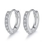 Detailed view of round zircon-studded silver hoop earrings