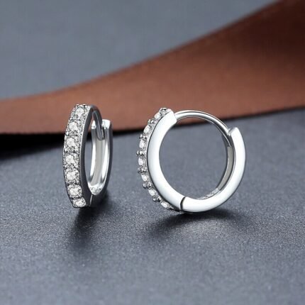 925 sterling silver hoop earrings with zircon stones on leather background
