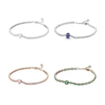 Collection of four sparkling tennis bracelets in silver, blue, rose gold pink and green